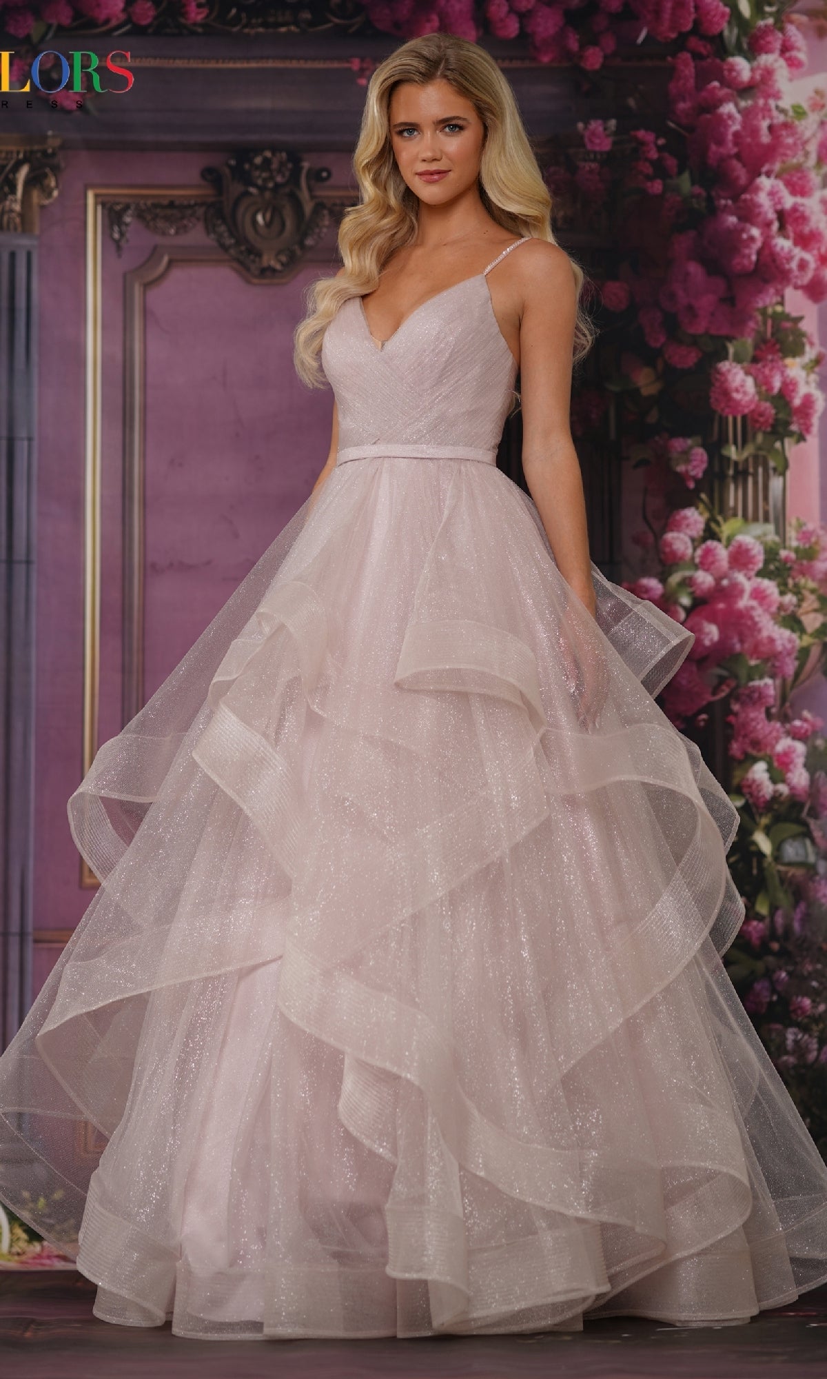 A woman wearing the Layered Long Tulle Prom Ball Gown 2381 poses in front of a floral and ornate purple backdrop.